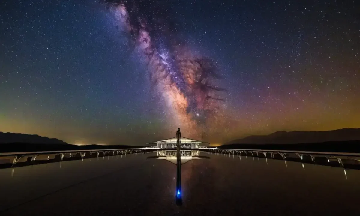 A vast starry sky showcases Earths vibrant colors and city lights